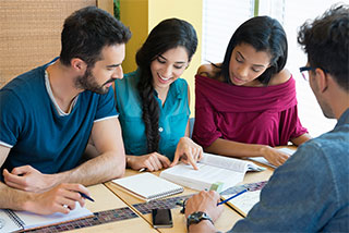 Group of students collaborating and studying together at a table.